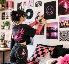 Gen Z decorating a colorful wall with posters in a stylish bedroom.