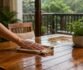 Person wiping a wet wooden table during the rainy season.