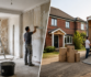Home renovation and moving: workers plastering walls and loading boxes into a truck.
