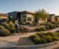 Modern suburban home with landscaped garden and people walking a dog.