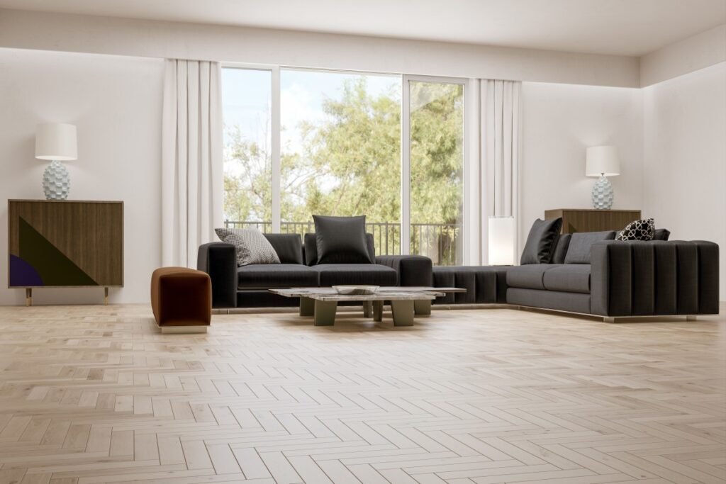 Modern luxury living room with black sofas, large windows, and light wood flooring.